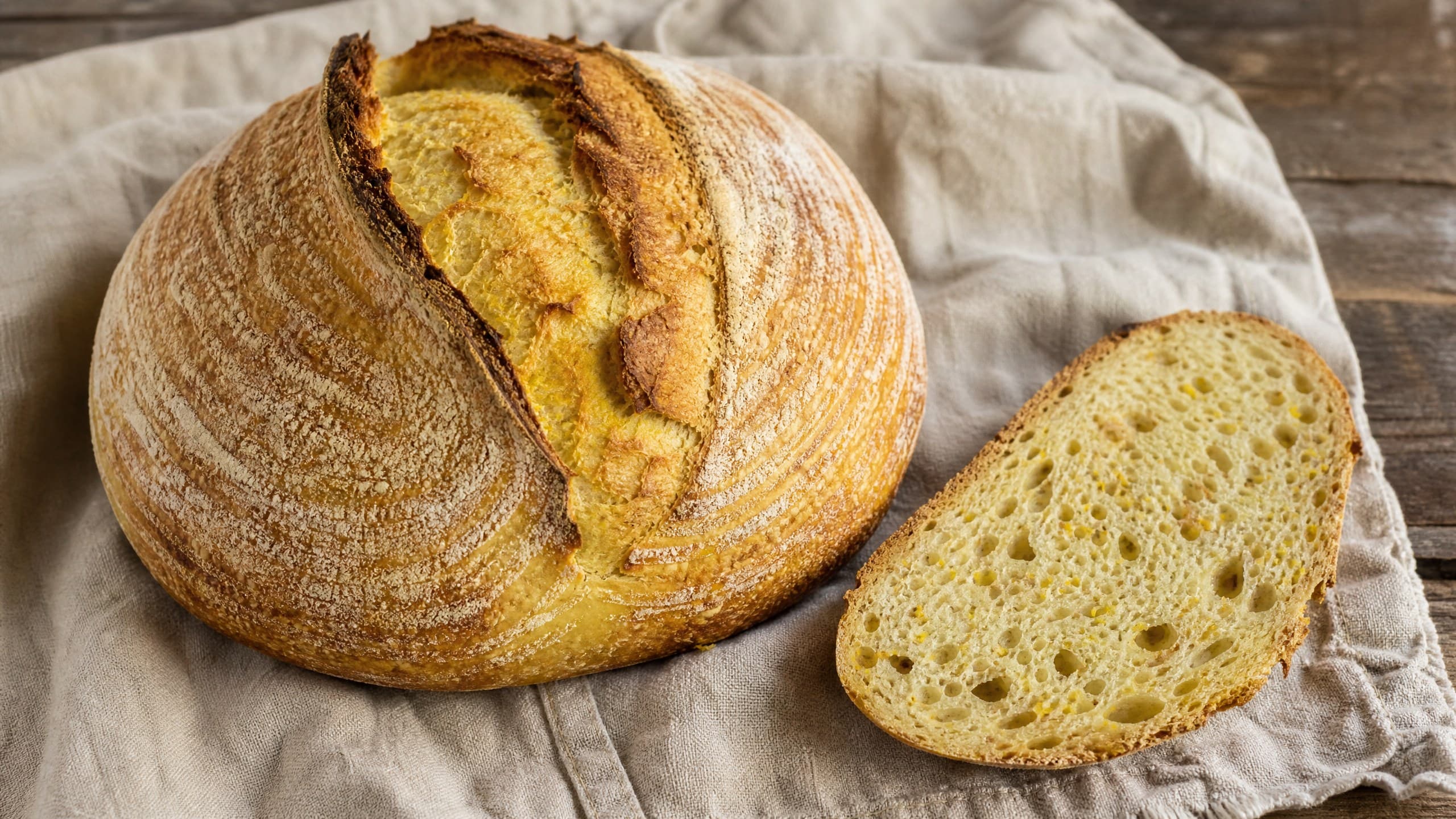 Freshly baked sourdough semolina bread: golden, nutty, durum crumb, photographed on a warm cream background