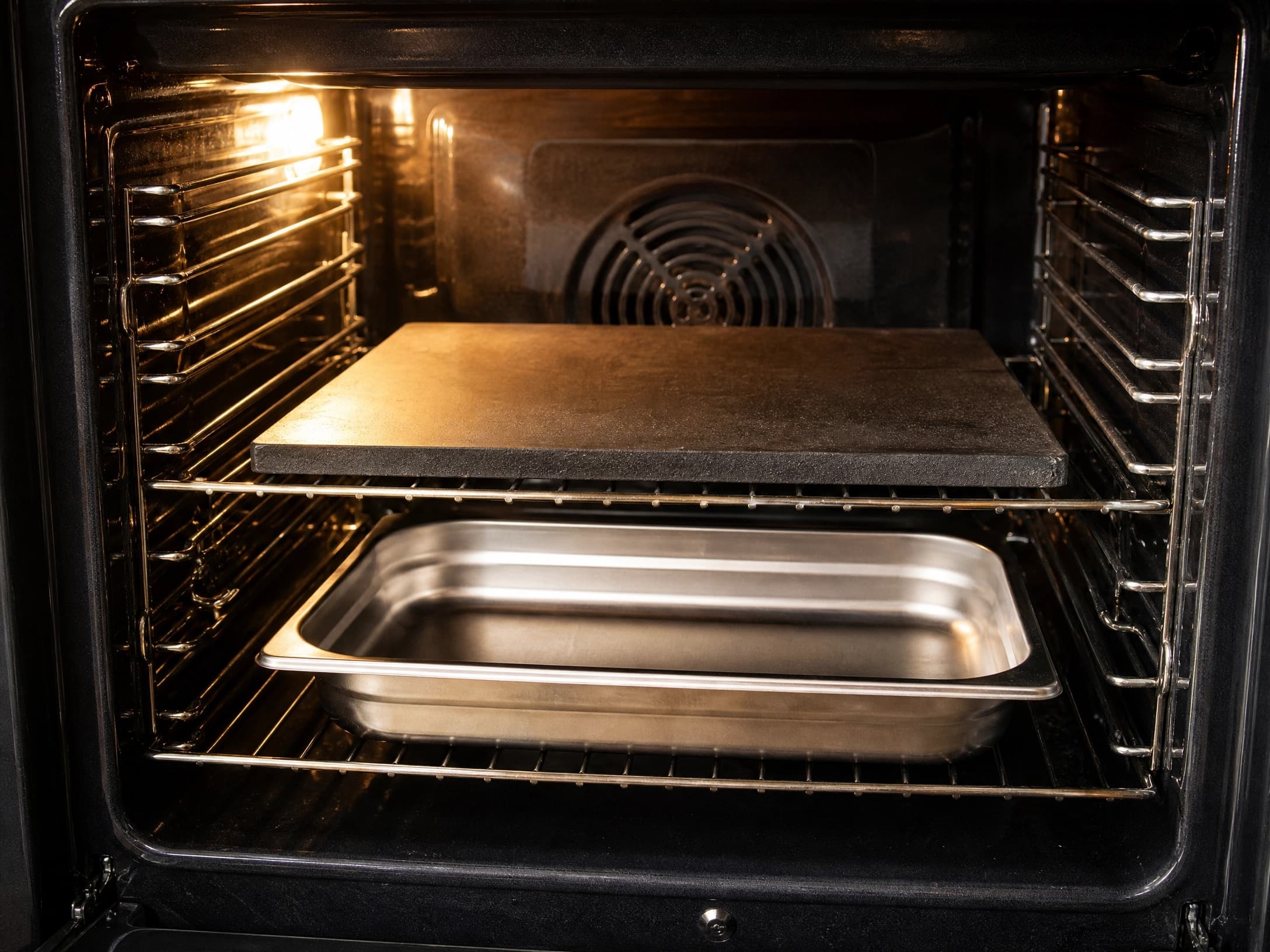 Oven preheating with a baking steel and a shallow steam pan inside