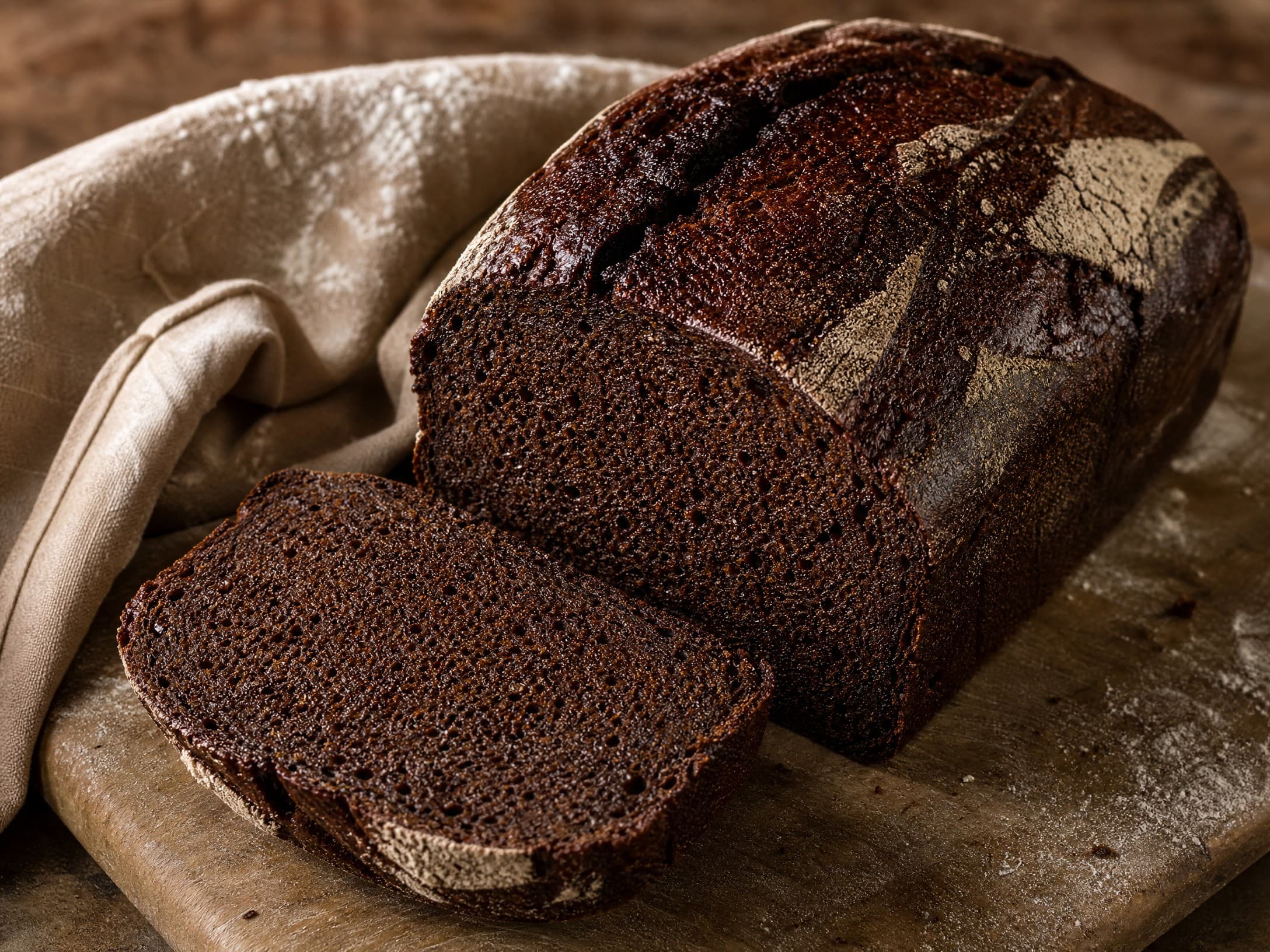 Freshly baked 90% rye sourdough bread (dark rye) recipe, photographed on a warm cream background