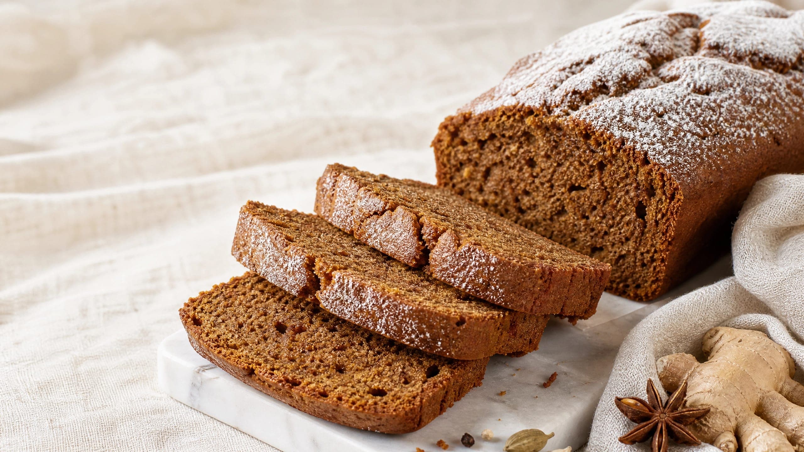 Freshly baked sourdough gingerbread, photographed on a warm cream background